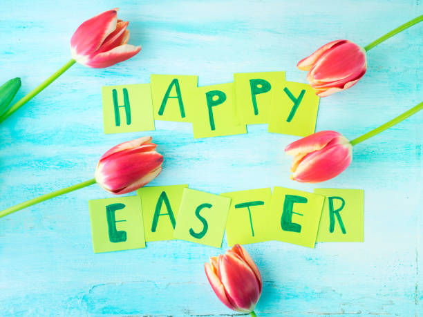 istock Happy Easter background tulips flowers hand written letters 643305706