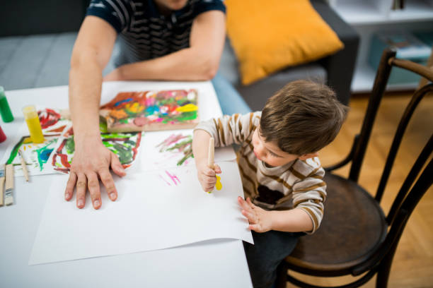 istock Little boy painting 643309432