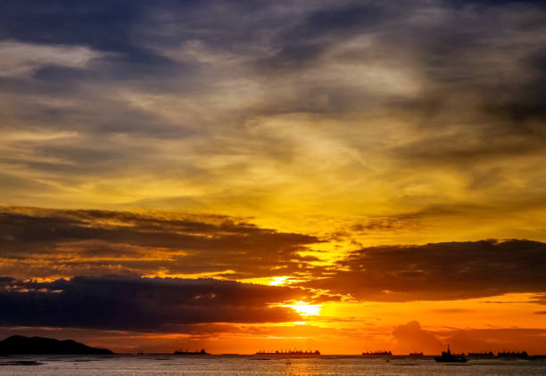 istock Nice sunset sky at sea with cargo ship silhouette 643310734