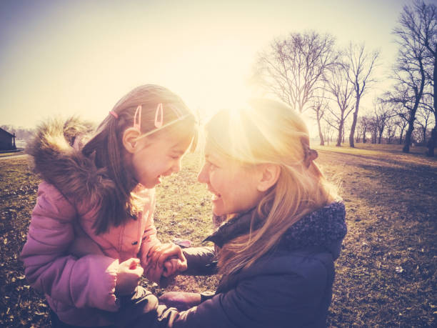 istock Mother and daughter smiling together at sunset 643313420