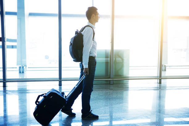 istock Businessman walking in airport corridor 643313546