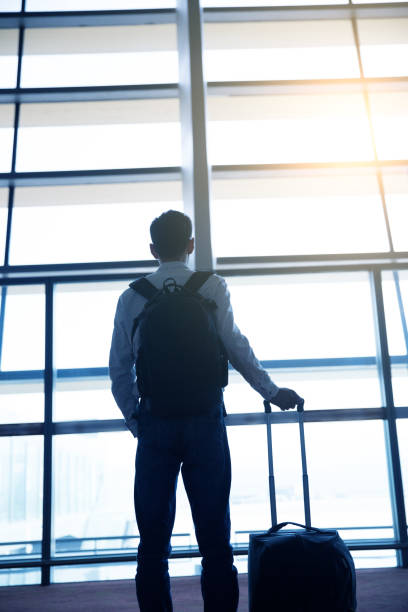 istock Businessman waiting in airport corridor 643313844