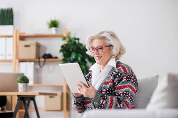 istock Senior woman digital tablet at home 643320084