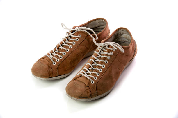 istock Old Velvet Brown Shoes isolated on white background 643321704