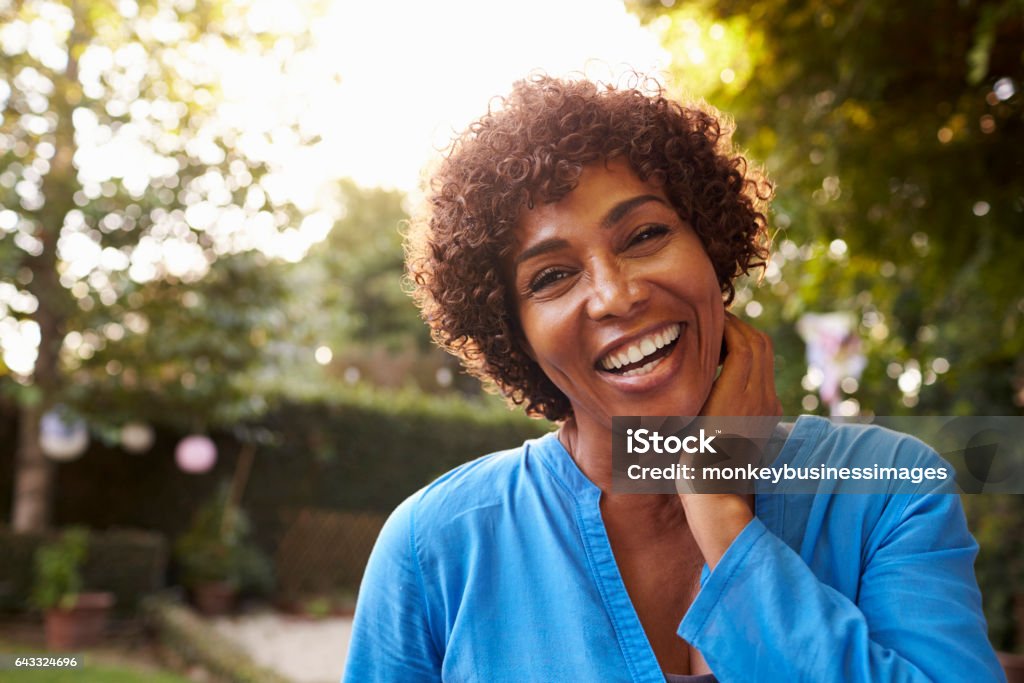 Portrait Of Mature Woman In Back Yard Garden Women Stock Photo