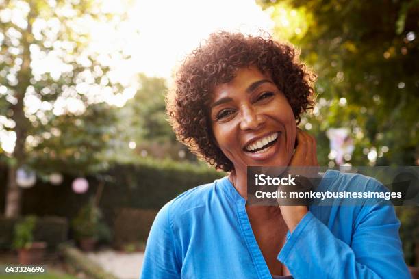 Portrait Of Mature Woman In Back Yard Garden Stock Photo - Download Image Now - Women, One Woman Only, Happiness