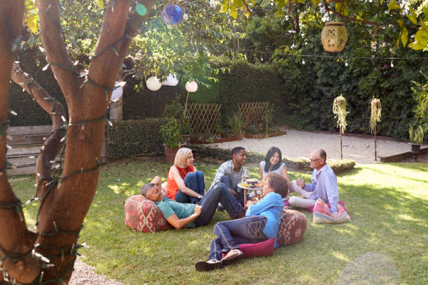 istock Group Of Mature Friends Enjoying Drinks In Backyard Together 643324890