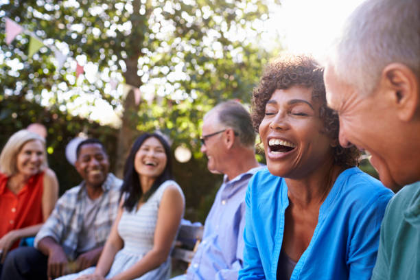 Group Of Mature Friends Socializing In Backyard Together Group Of Mature Friends Socializing In Backyard Together happiness four people cheerful senior adult stock pictures, royalty-free photos & images