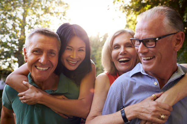 istock Mature Friends Giving Piggybacks In Backyard Together 643325010