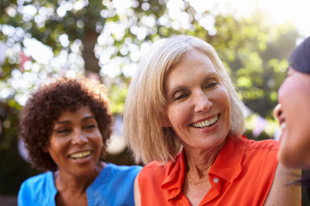 istock Mature Female Friends Socializing In Backyard Together 643325100