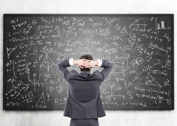 istock Businessman looking at formulas at blackboard 643332912