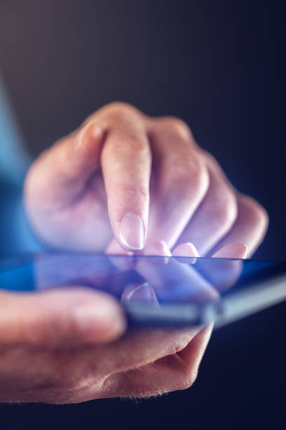 istock Close up of female finger touching smartphone screen 643336192