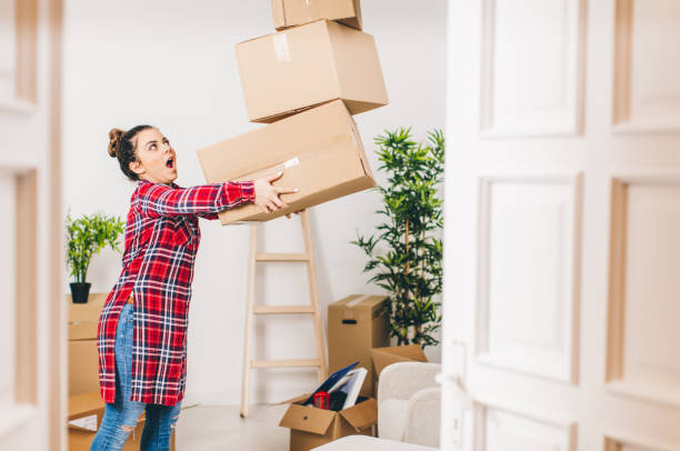 istock New beginings, woman unpacking at home 643339166