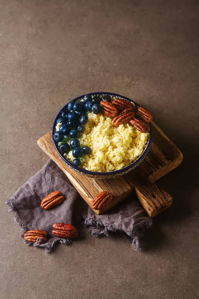 istock Wheat cereal with blueberries and nuts. Dark gray background. 643342320