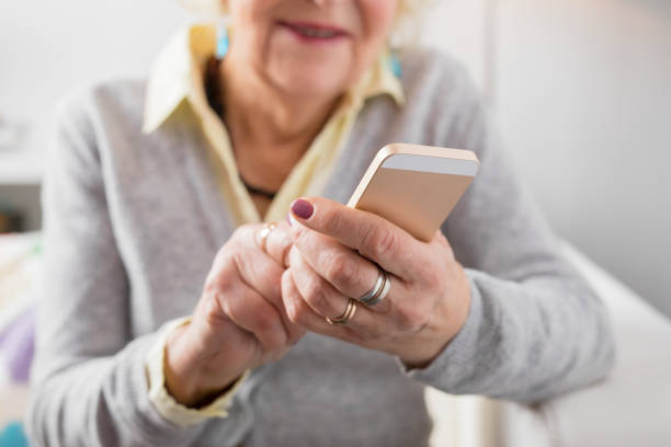 istock Senior woman holding smartphone 643343510