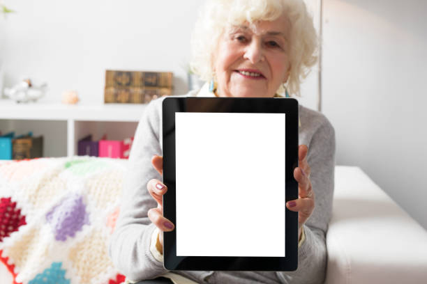 Senior woman showing tablet computer