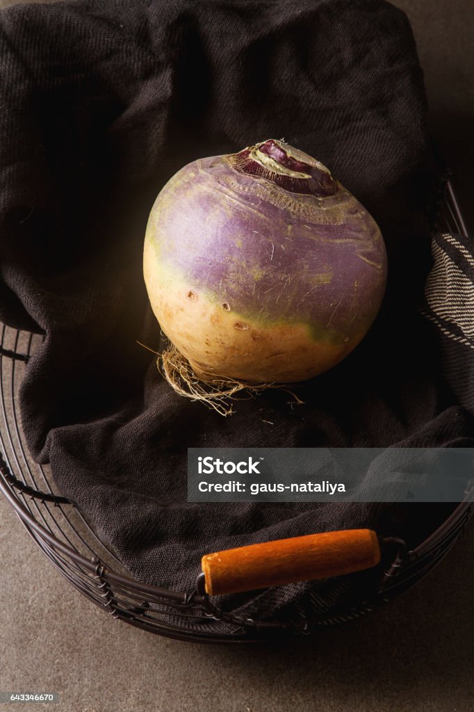 Ripe purple turnips with green leaves. Grey stone background. Ripe purple turnips with green leaves. Grey stone background Close-up Stock Photo