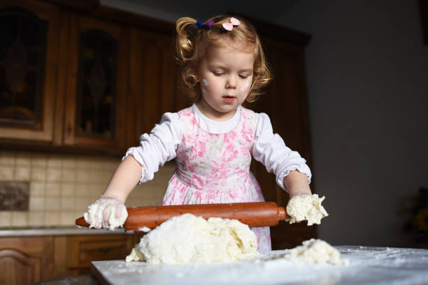 istock little girl kneading dough 643350152