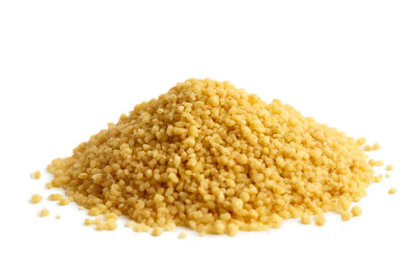 Heap of dry couscous isolated on white.