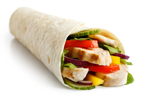 Grilled chicken and salad tortilla wrap isolated on white.