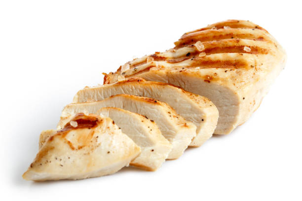 Partially sliced grilled chicken breast with black pepper. Partially sliced grilled chicken breast with black pepper and rock salt isolated on white. grilled chicken breast stock pictures, royalty-free photos & images