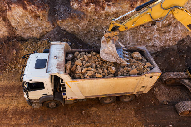 istock Excavator loading truck in excavation area 643360650