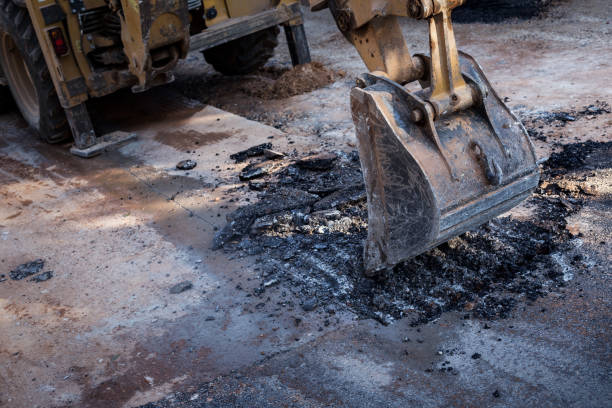istock Excavator breaking asphalt for renewal 643362332
