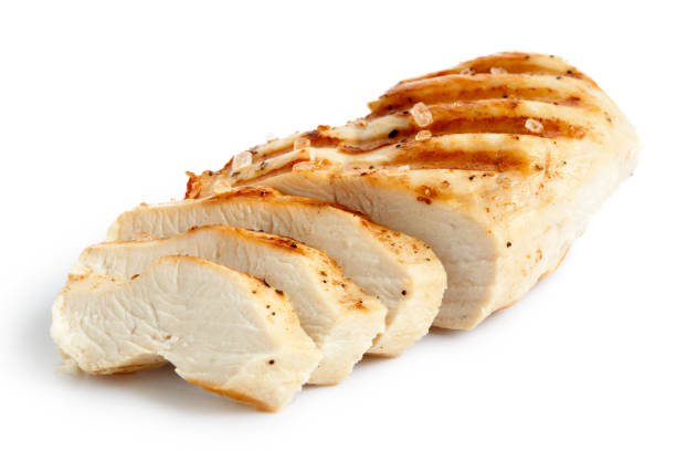 Partially sliced grilled chicken breast with black pepper. Partially sliced grilled chicken breast with black pepper and rock salt isolated on white. chicken meat photos stock pictures, royalty-free photos & images