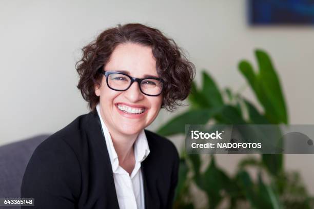 Spanish Businesswoman Smiling At The Camera At The Office Stock Photo - Download Image Now