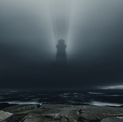 The shadow of Peggy's Cove Lighthouse is projected onto low level clouds above.  Long exposure shot at high iso.