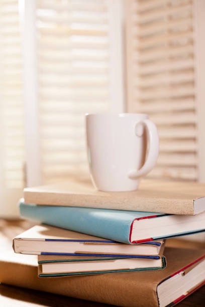 istock Stack of books on table or desk with coffee. 643375798