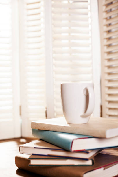 istock Stack of books on table or desk with coffee. 643375938