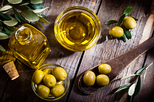 Aceite de oliva y aceitunas verdes tiran desde arriba photo