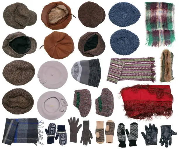 Warm winter clothes from a family case of a rural family - caps, scarfs, gloves. Isolated handmade set