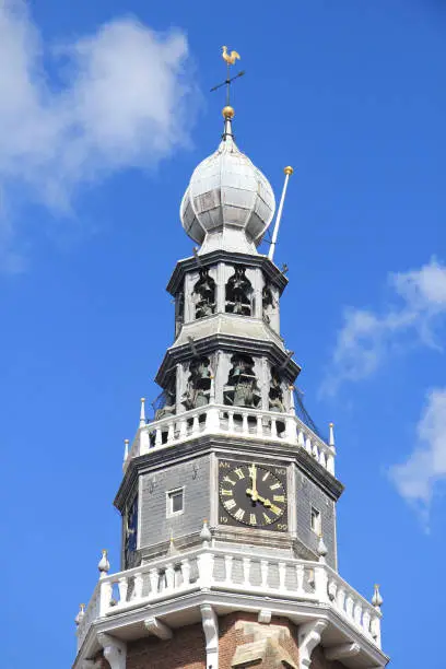 Church tower with a beautiful clock, and blue sky in the background