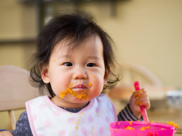 istock eating mess baby girl 643393534