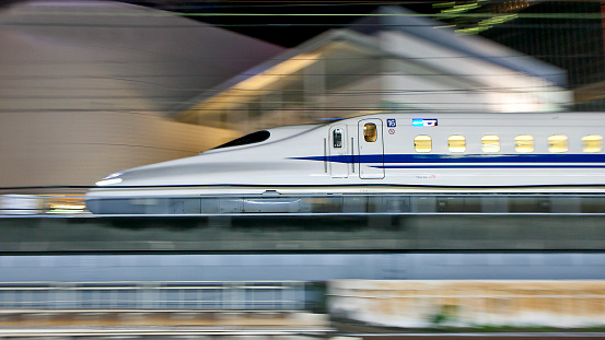 Tokyo, Japan - September 4, 2014: N700 series Shinkansen bullet train approaches Tokyo Station in the night.