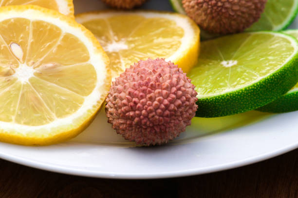 Lemon, Lime and Orange Arranged on Blue Background
