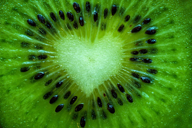 fruit kiwi close up with form of heart background stock photo