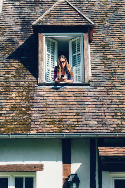 istock Girl texting on the rooftop window 643402986