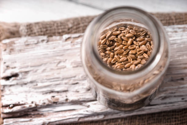istock Wheat seeds in a glass jar on a white rustic 643409434