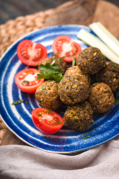 istock Falafel with tomato and celery on a blue plate 643412632