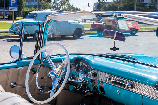 Havana, Cuba - January 22, 2014: Vintage american cars parked in the main street of Old Havana.