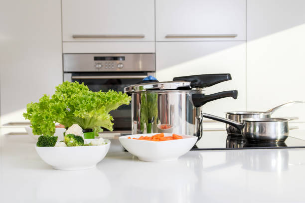 istock Pressure cooker and vegetables prepared to be cooked. 643415868