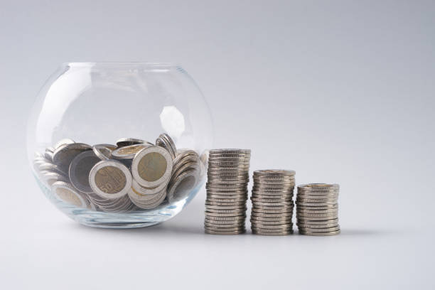 istock coins stack and piggy bank with coins on isolated white 643416014