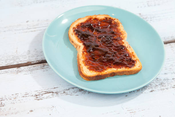 istock Typical Dutch apple syrup called Appelstroop on bread on wooden background 643420750