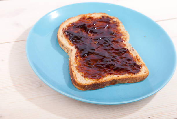 istock Typical Dutch apple syrup called Appelstroop on bread on wooden background 643420758