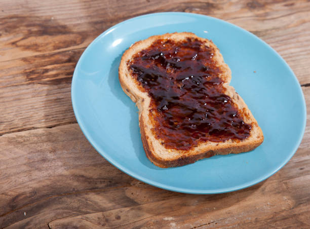 istock Typical Dutch apple syrup called Appelstroop on bread on wooden background 643420772