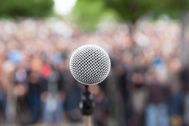 istock Microphone in focus, blurred crowd in background. Political rally. 643424334