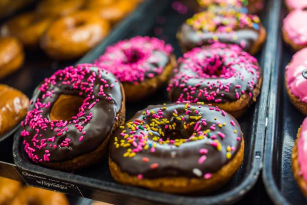 istock Chocolate iced donuts with pink sprinkles 643424946